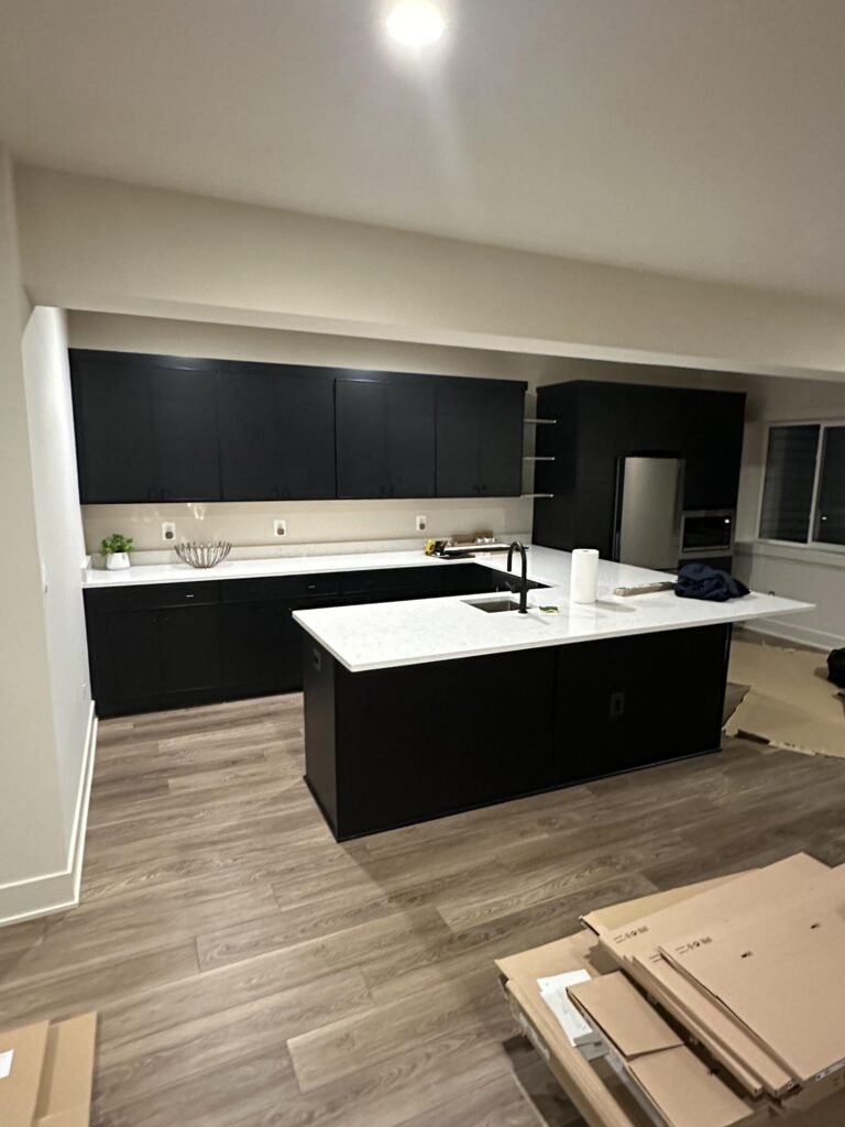 Finished kitchen renovation by ZEFI GROUP with dark cabinets and stone countertops