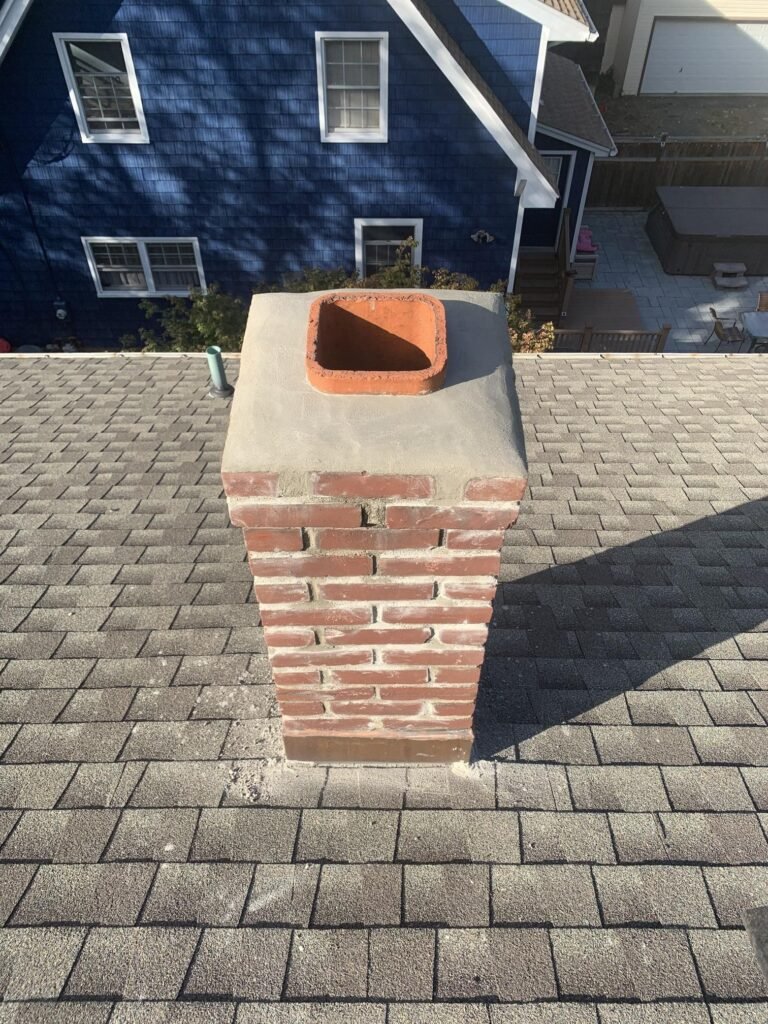 Chimney repair and flashing detail on a shingle roof